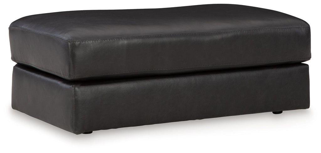 Onyx leather ottoman with padded top and squared arms, short legs