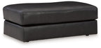Onyx leather ottoman with padded top and squared arms, short legs
