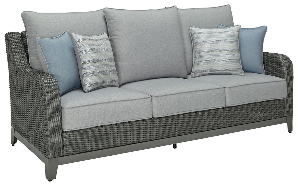 Gray woven outdoor sofa with seat cushions and light blue striped pillows