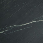 Black marble tabletop close-up with subtle white-gray veining