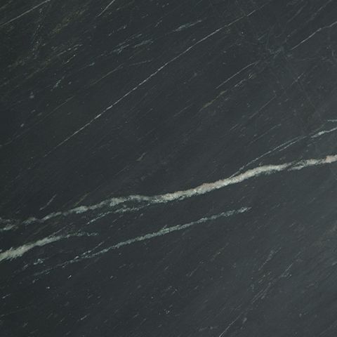 Black marble tabletop close-up with subtle white-gray veining