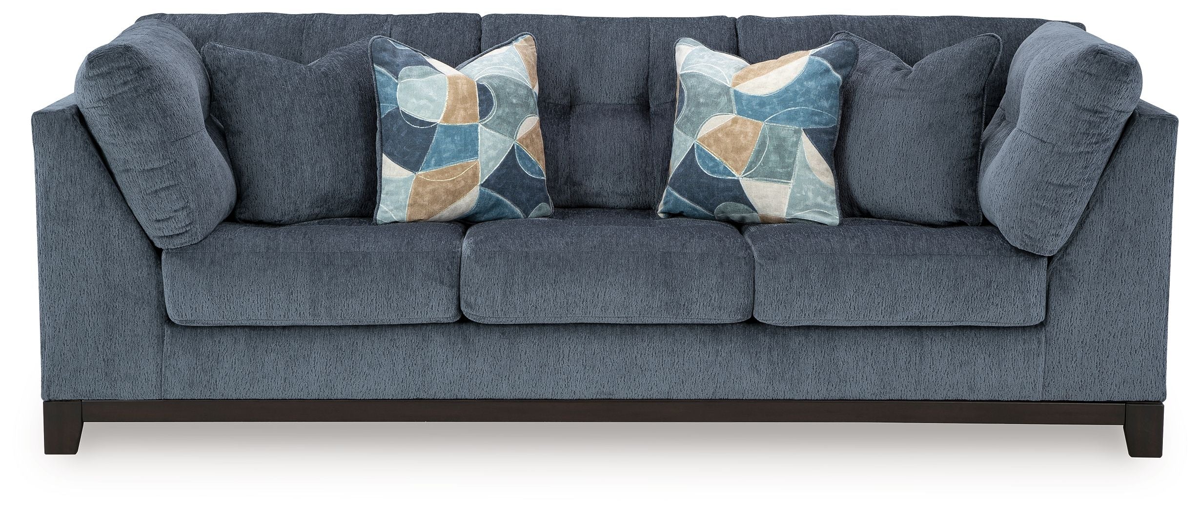 Navy fabric sofa with tufted arms and three decorative geometric throw pillows