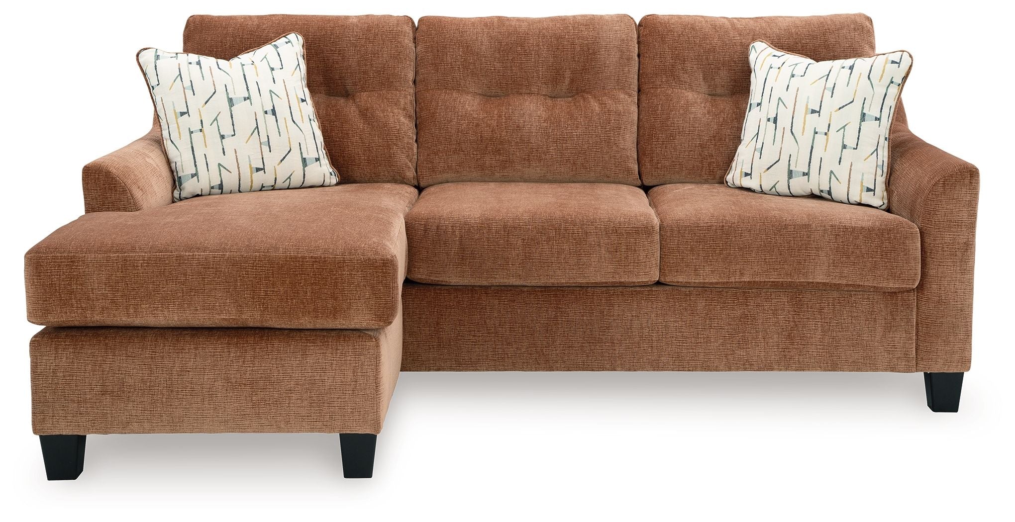 Clay sofa chaise with two square patterned throw pillows and tufted back cushions