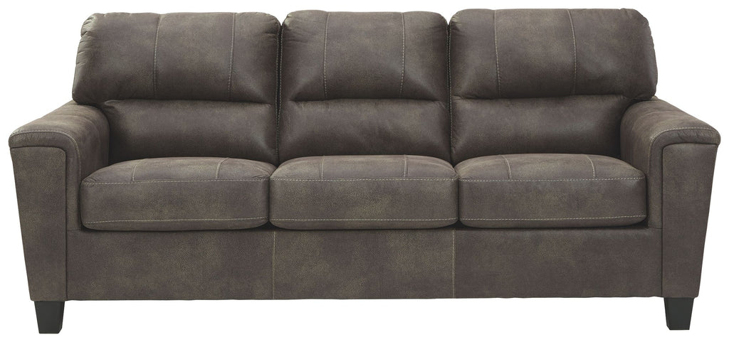 Dark gray sleeper sofa with tufted back cushions and rolled arms