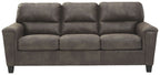 Dark gray sleeper sofa with tufted back cushions and rolled arms