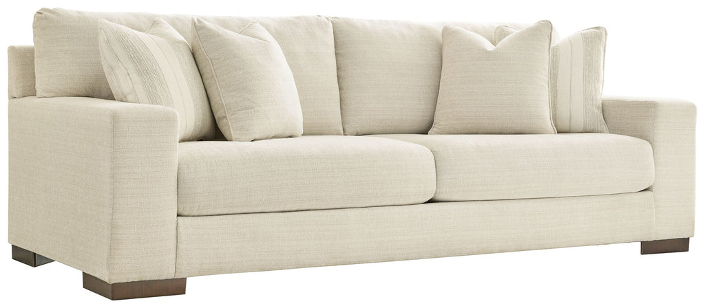 Light beige sofa with rolled arms and multiple back cushions