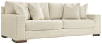 Light beige sofa with rolled arms and multiple back cushions