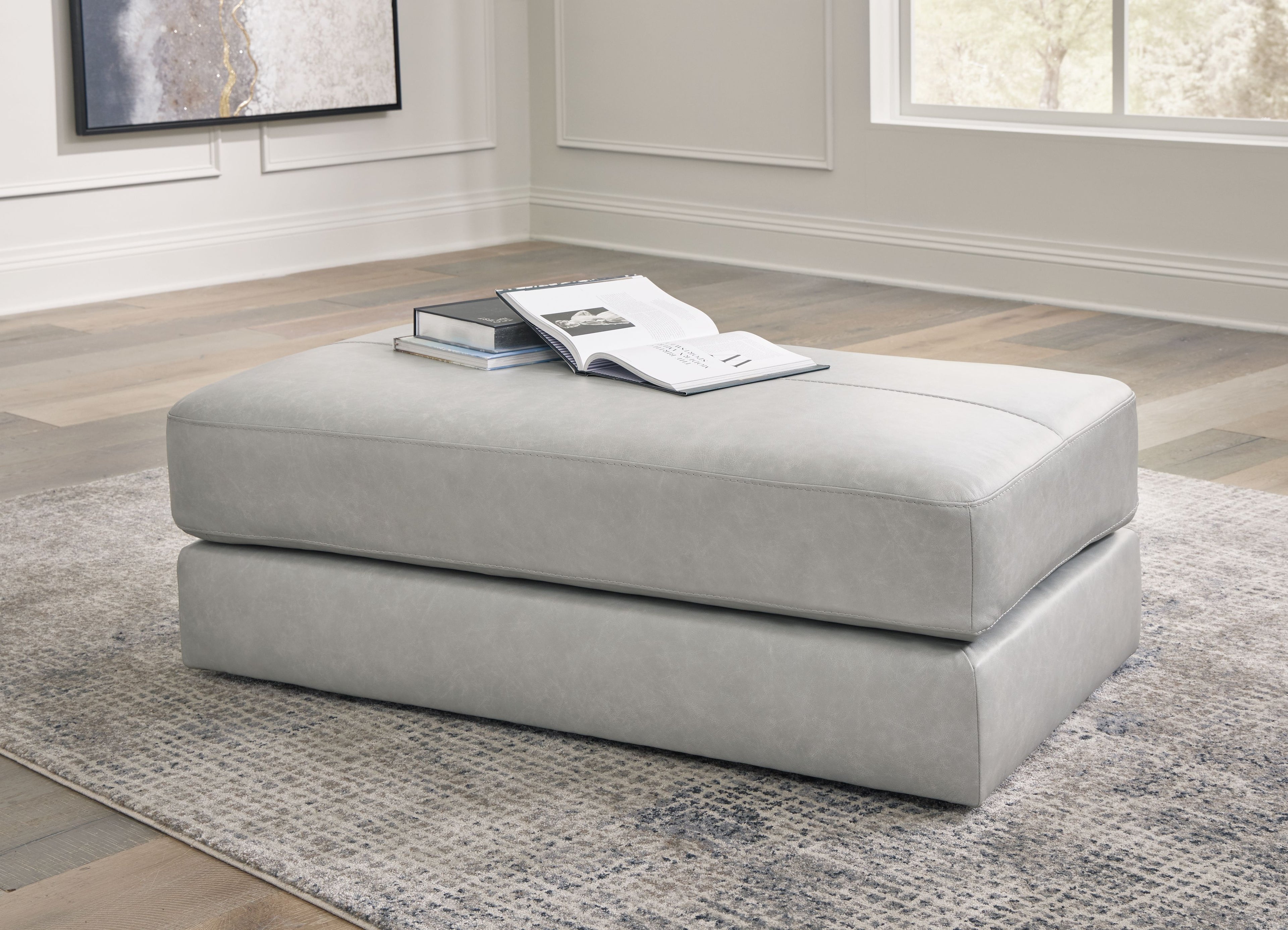Oversized accent ottoman in pearl silver, squared cushioned top and base