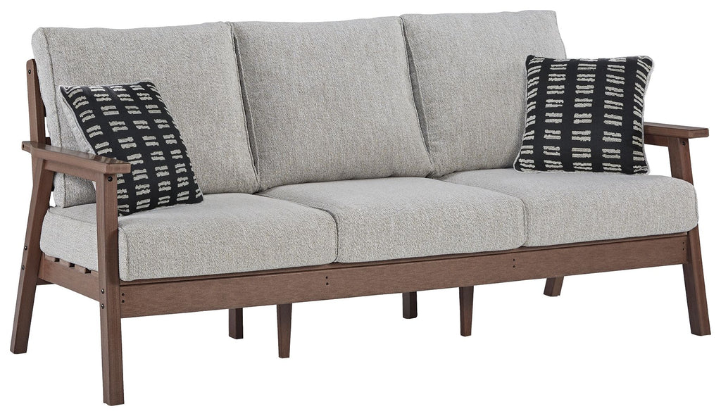 Grey upholstered sofa with two black-and-white patterned throw pillows