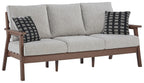 Grey upholstered sofa with two black-and-white patterned throw pillows