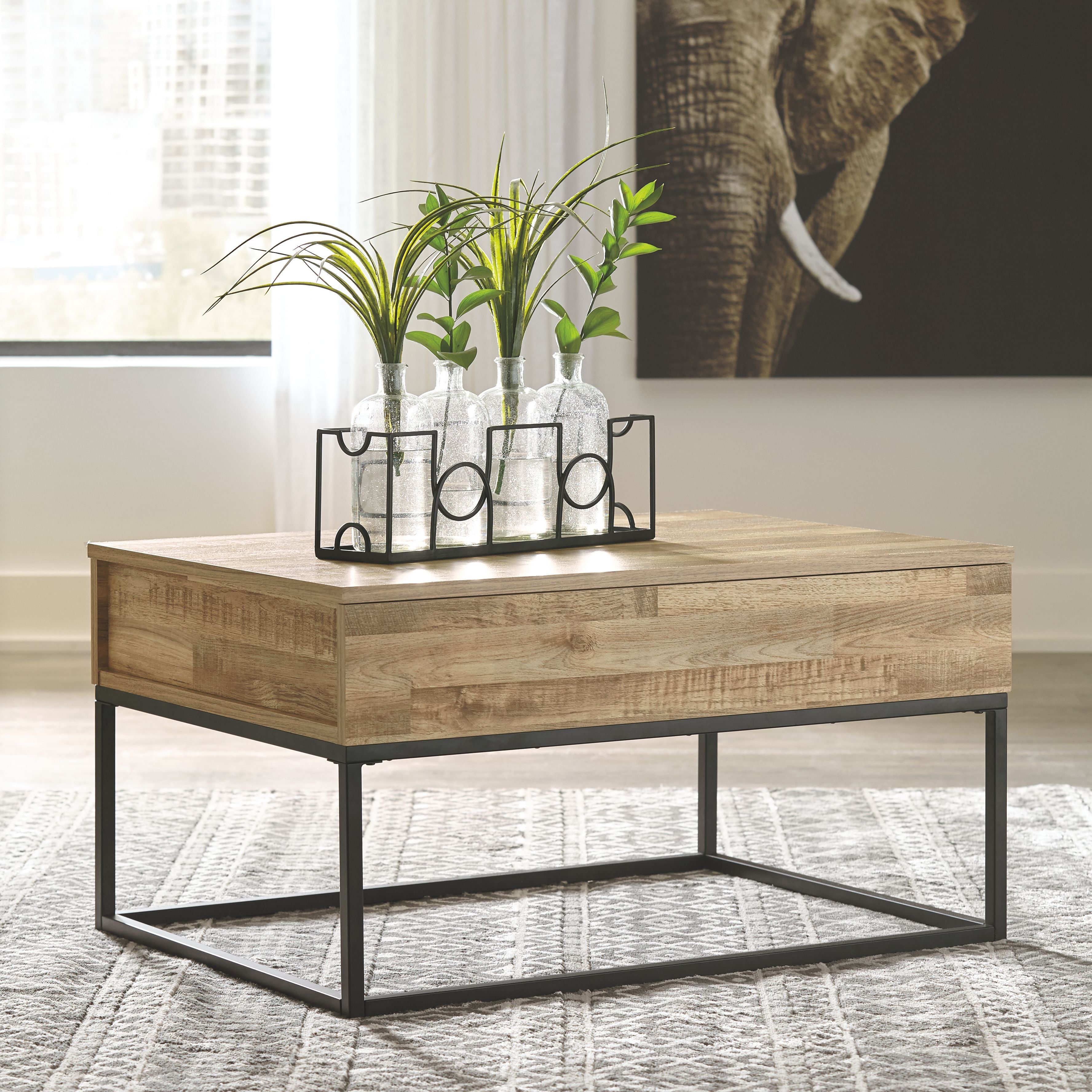 Lift-top cocktail table with light wood drawer-style top and black metal base