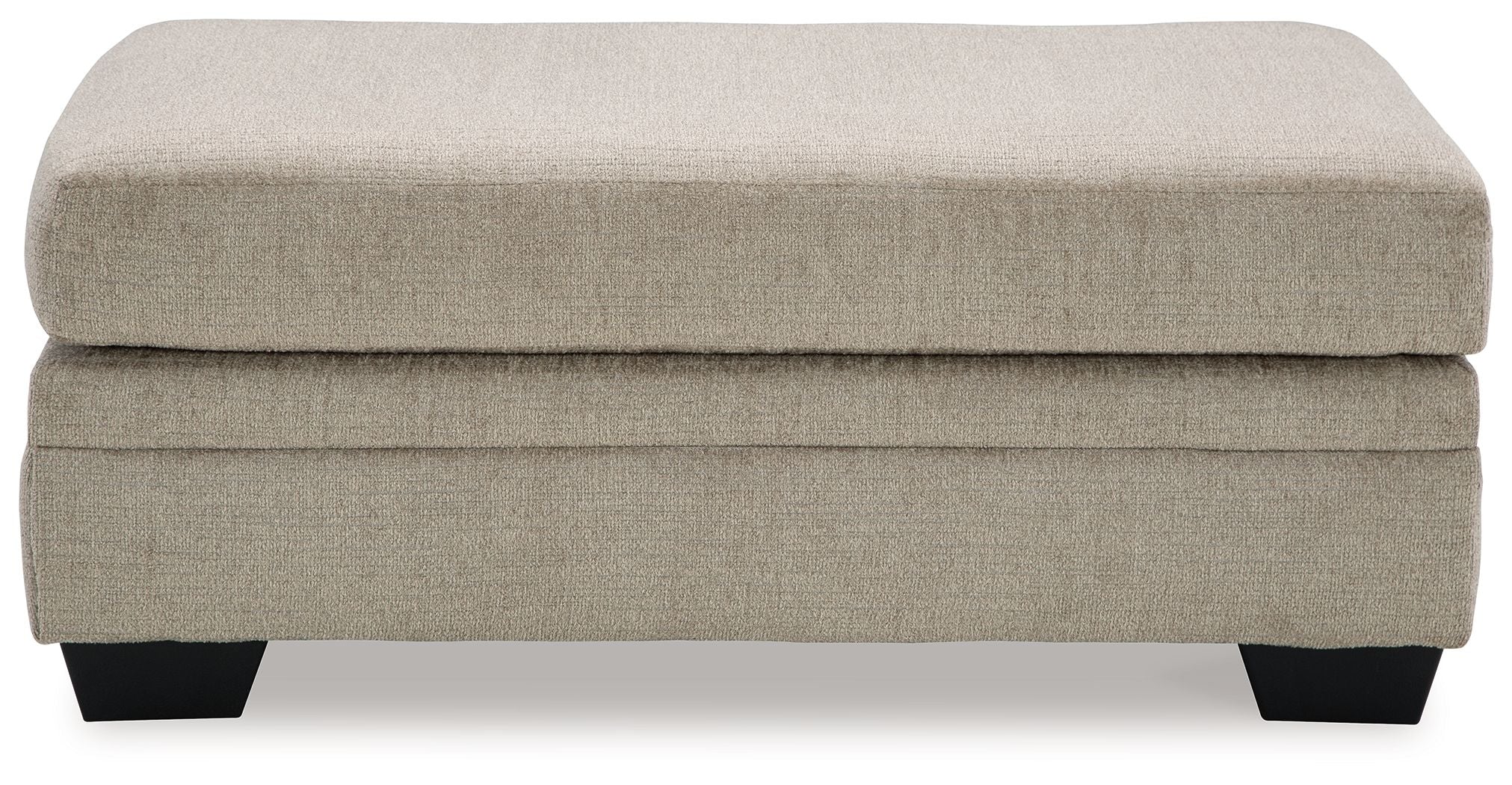 Upholstered ottoman with light beige fabric top, stacked base, black legs.