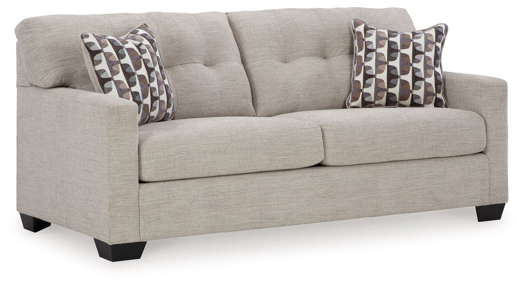 Pebble sofa sleeper with two patterned throw pillows and wide padded arms