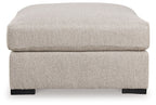 Sand-colored oversized ottoman with padded top and dark block feet