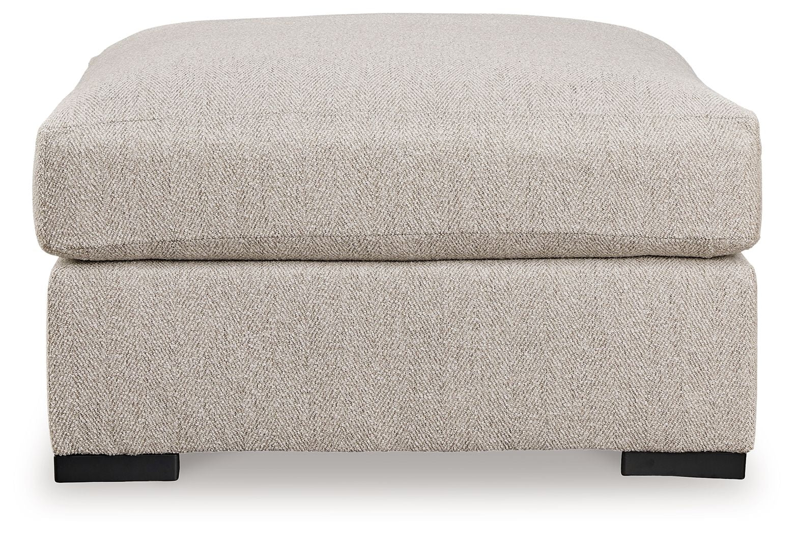 Sand-colored oversized ottoman with padded top and dark block feet