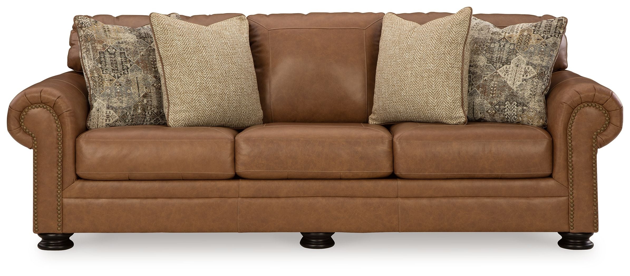 Caramel queen sofa sleeper with tufted seat, rolled arms, and patterned & tan throw pillows
