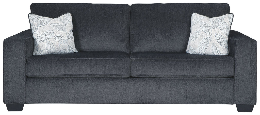 Slate sleeper sofa with two square patterned throw pillows and rolled armrests