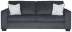 Slate sleeper sofa with two square patterned throw pillows and rolled armrests