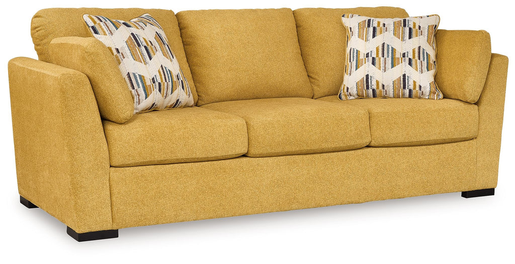 Keerwick sofa in sunflower yellow with two patterned throw pillows and three seat cushions