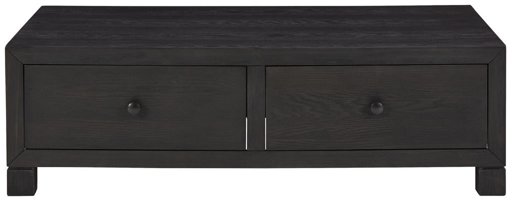 Dark wood cocktail table with two centered storage drawers and small round pulls