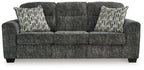 Lonoke sofa with dark gray upholstery and two patterned pillows