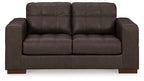 Dark brown loveseat with tufted back, padded arms, and two-seat cushions