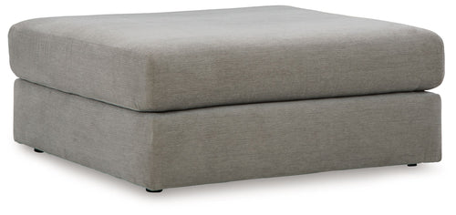 Upholstered ottoman in ash gray with rounded square top and low block feet