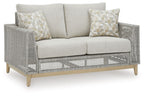 Gray woven loveseat with two seat cushions and three light patterned throw pillows