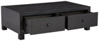 Dark wood cocktail table with storage drawer fronts, one drawer open and two pulls