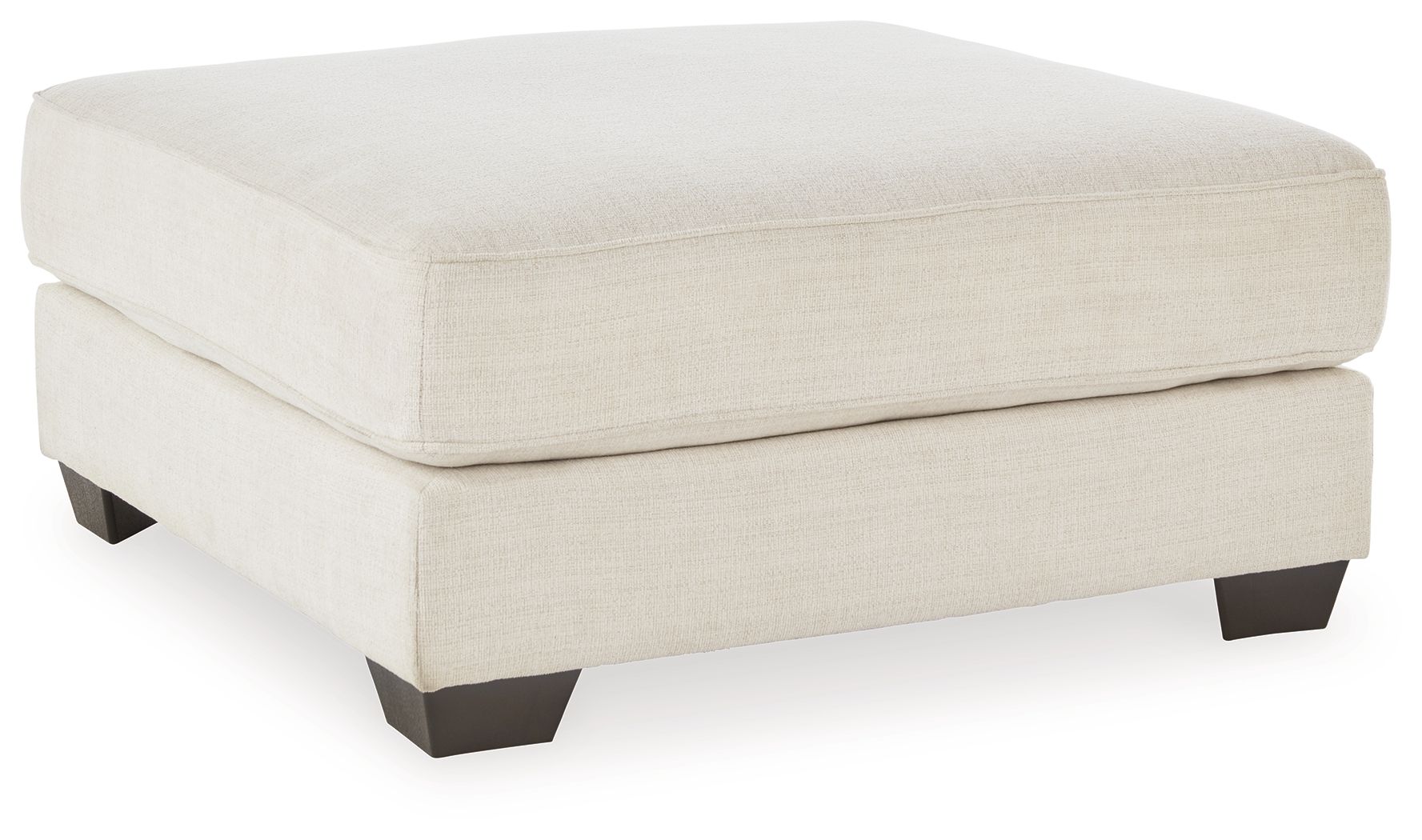Oversized ottoman with beige fabric upholstery and dark tapered feet.