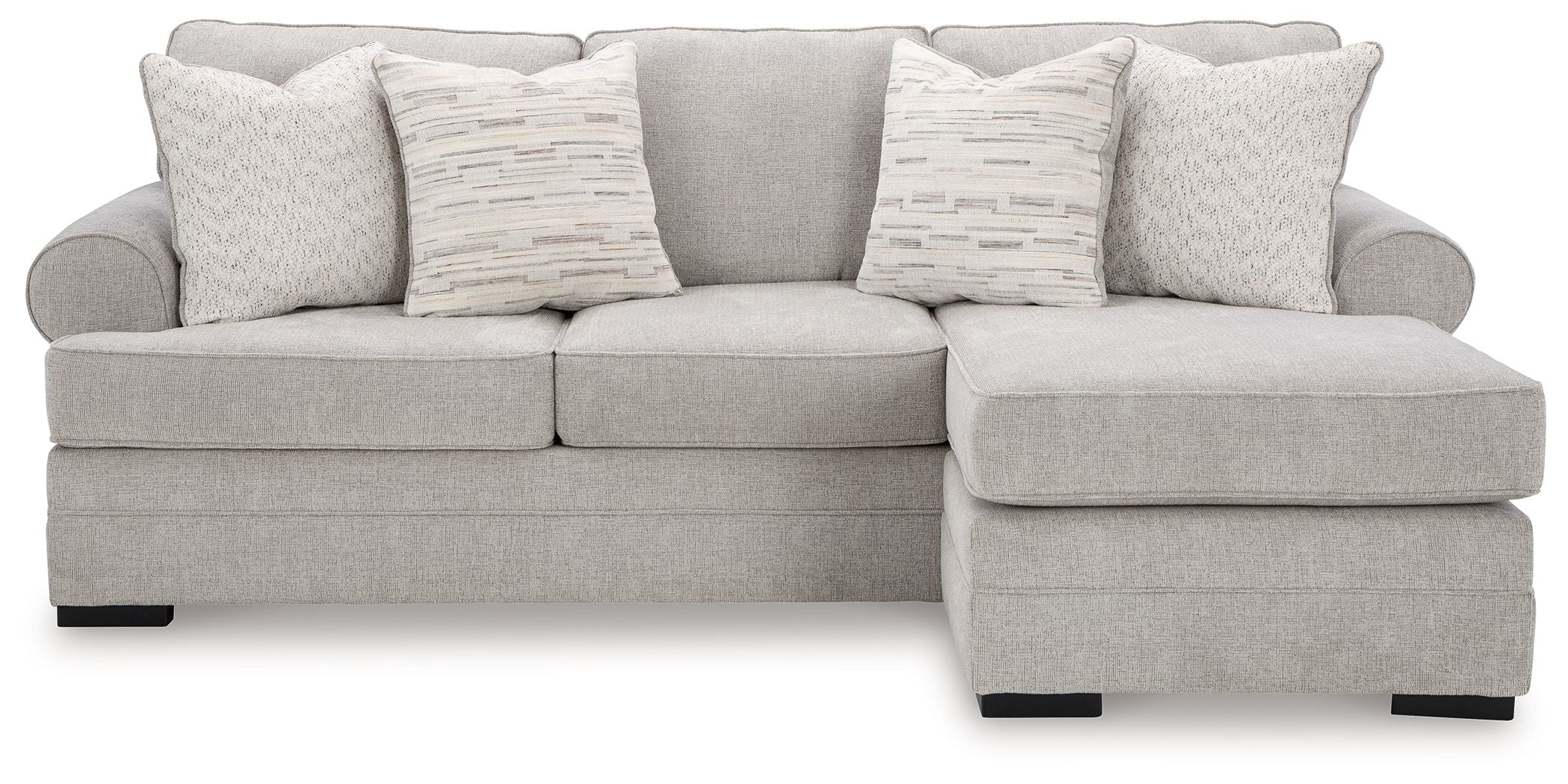 Light gray sofa chaise with wide chaise end, padded armrests, and three patterned throw pillows