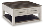 Lift-top cocktail table with dark brown slatted top, white drawers, and lower shelf