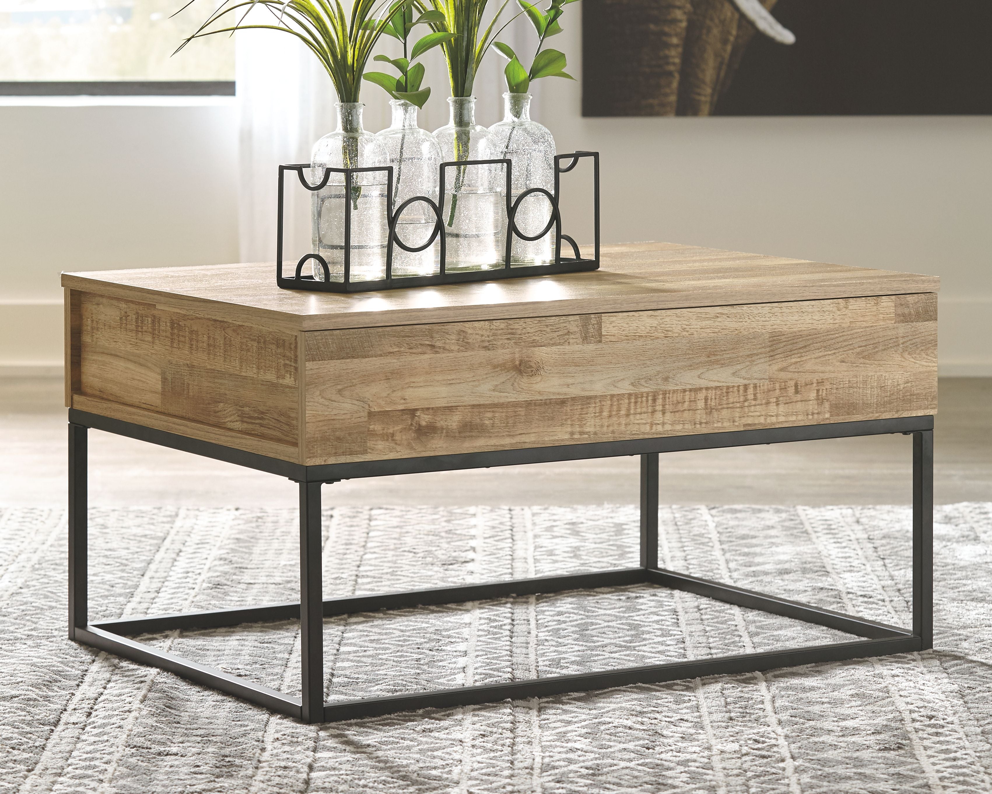 Light wood lift-top cocktail table with black metal base and open storage area
