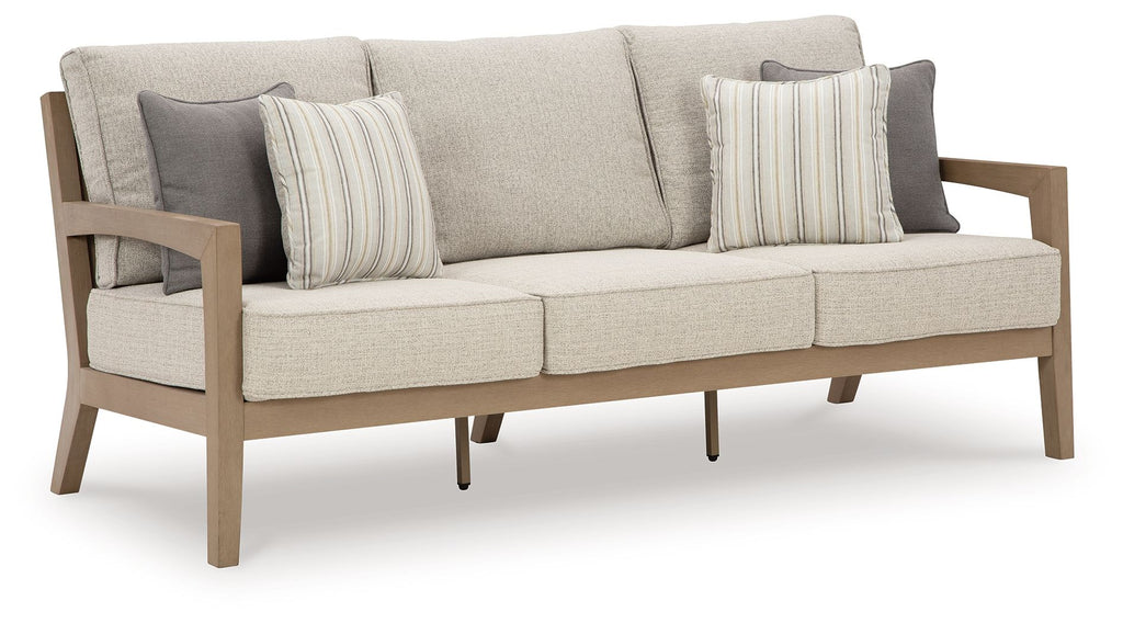 Beige fabric sofa with two striped throw pillows and matching back cushion, wooden arms