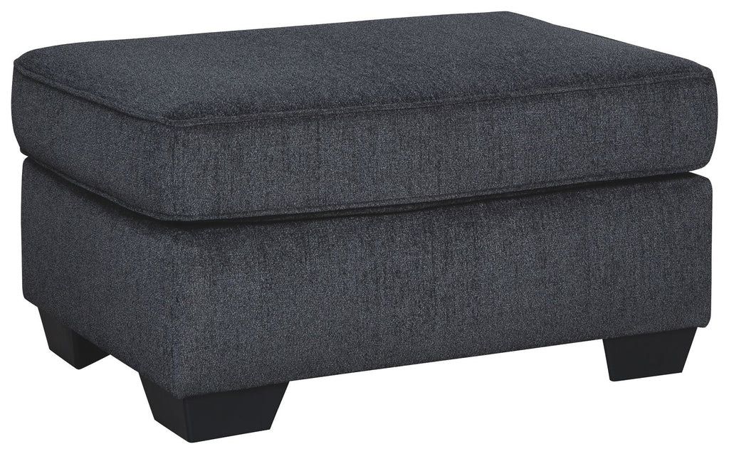 Upholstered dark gray ottoman with cushioned top and block legs