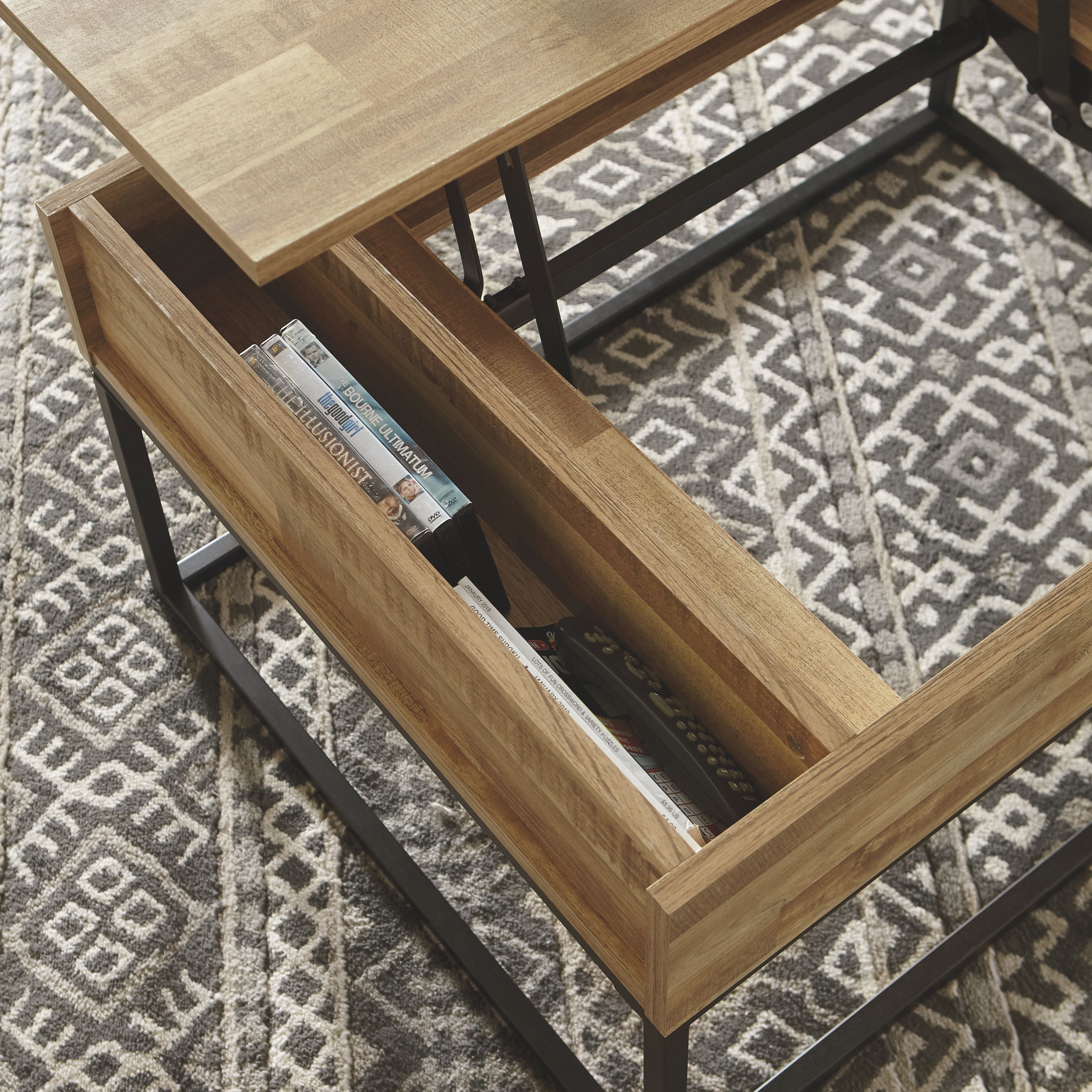 Interior lift-top tray area with light wood panels and black metal supports