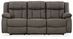 Gunmetal reclining sofa with padded armrests and three seat cushions