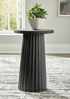 Black round accent table with planter on top