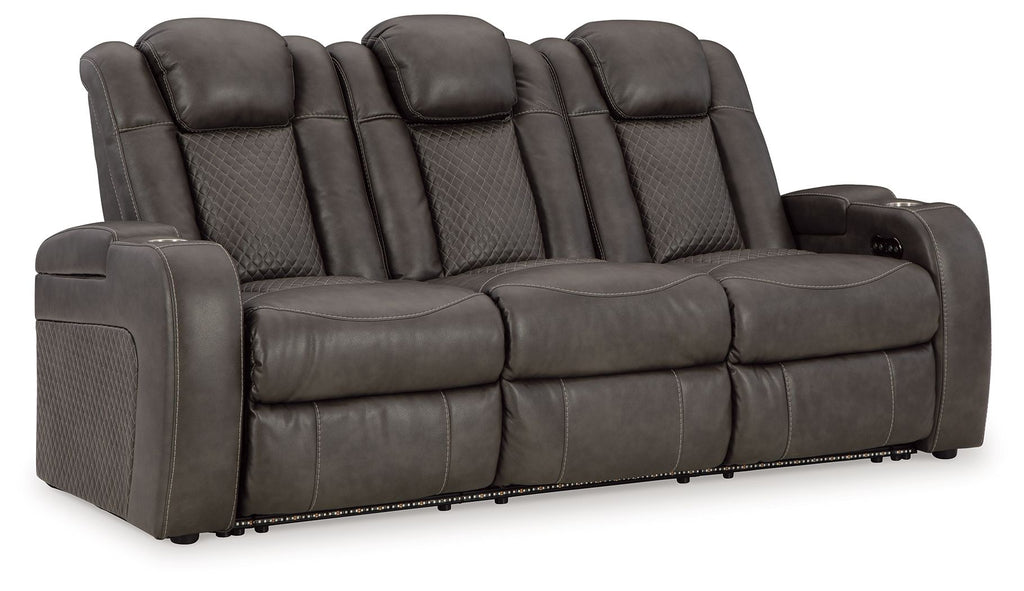 Power reclining sofa with padded adjustable headrests, dark gray upholstery