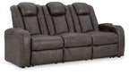 Power reclining sofa with padded adjustable headrests, dark gray upholstery