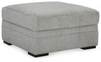 Cement gray fabric storage ottoman with hinged top and black feet