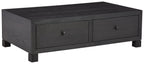 Dark wood cocktail table with storage drawers, two front drawers and block feet
