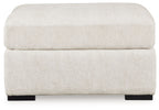 Ivory oversized accent ottoman with rounded top and fabric sides, black legs