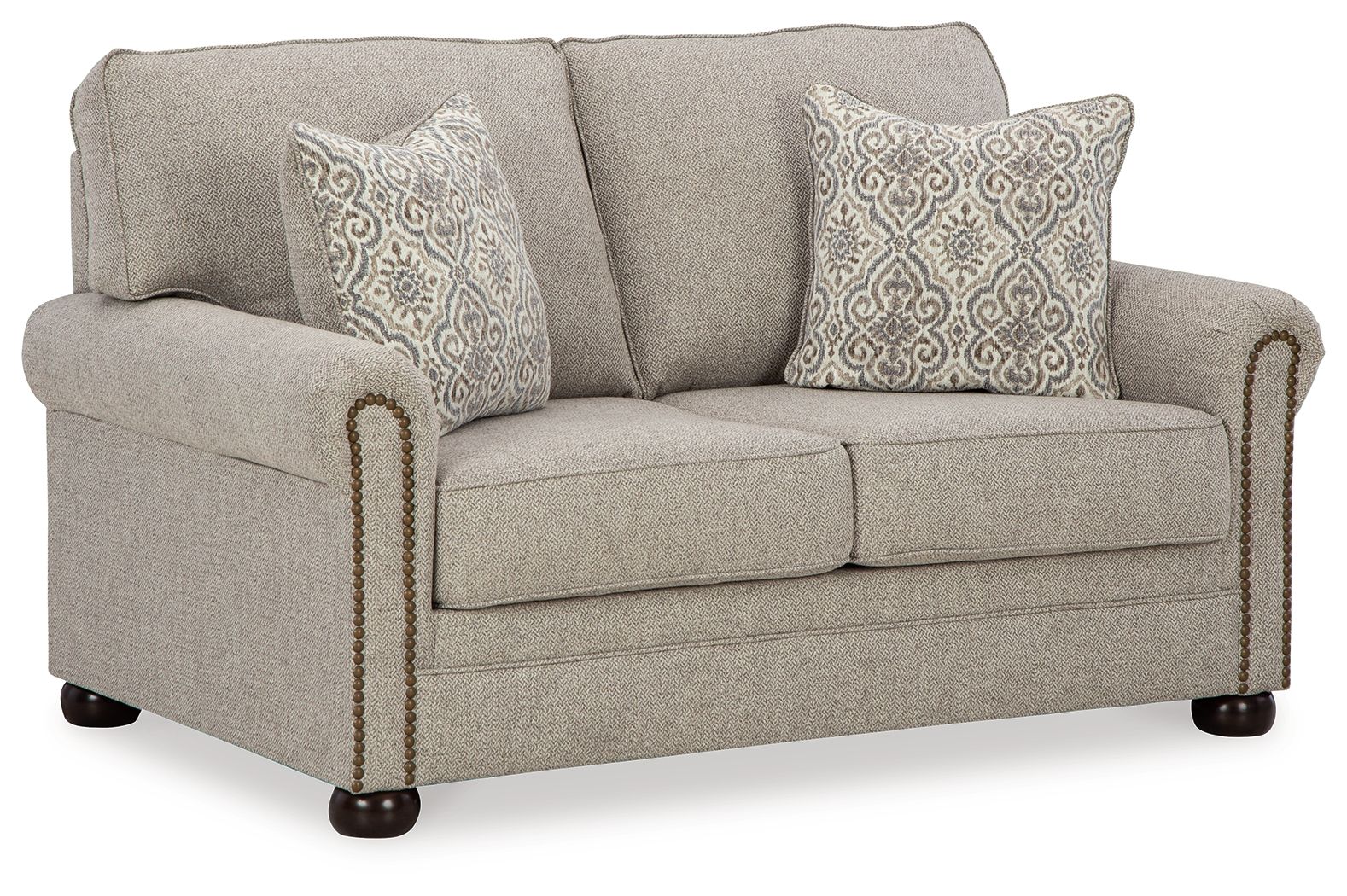 Light gray-beige loveseat with two patterned pillows and gold nail trim