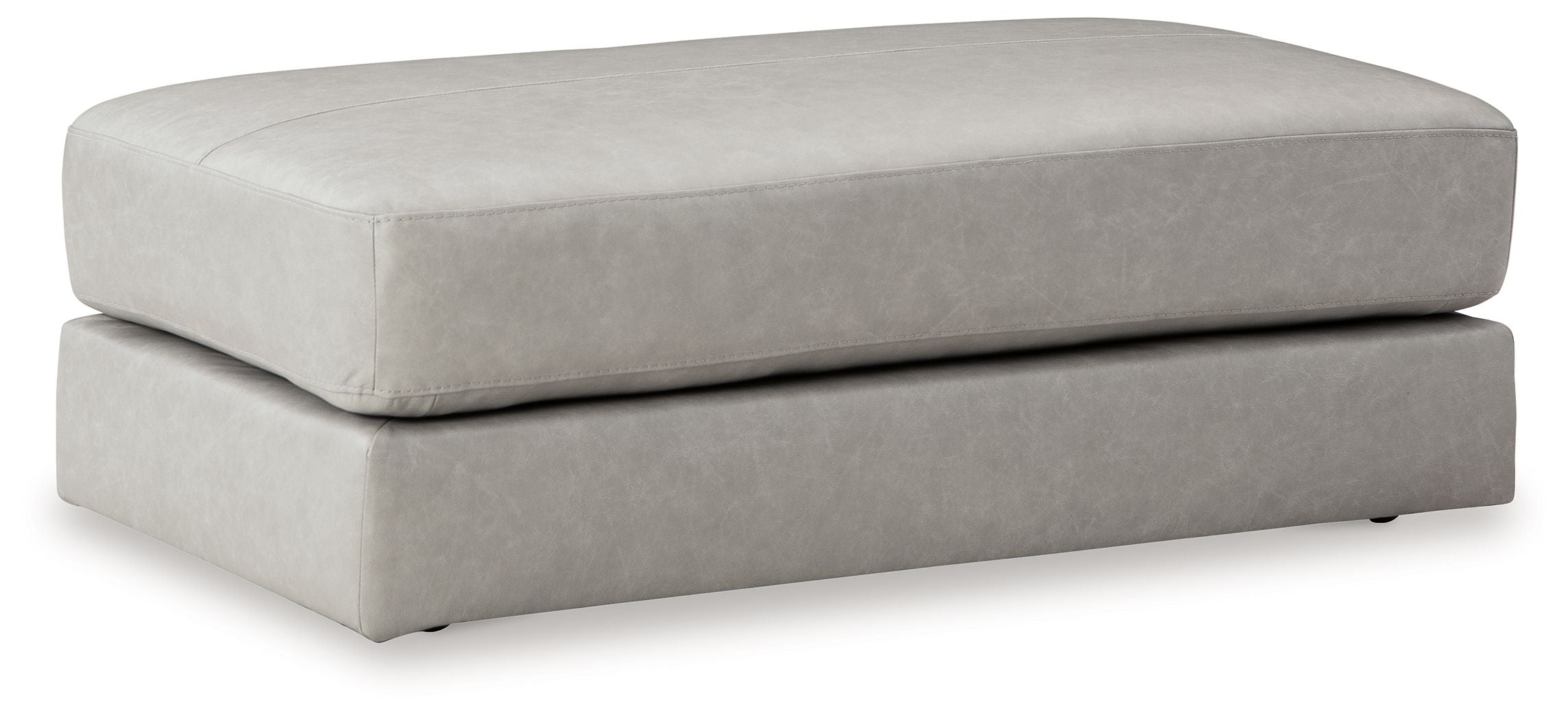 Light gray upholstered ottoman with two-tier rectangular base and cushioned top