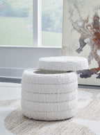 Ivory round storage ottoman with dense textured fabric and open lid