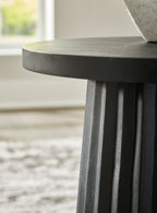 Grey-black fluted pedestal leg under round tabletop