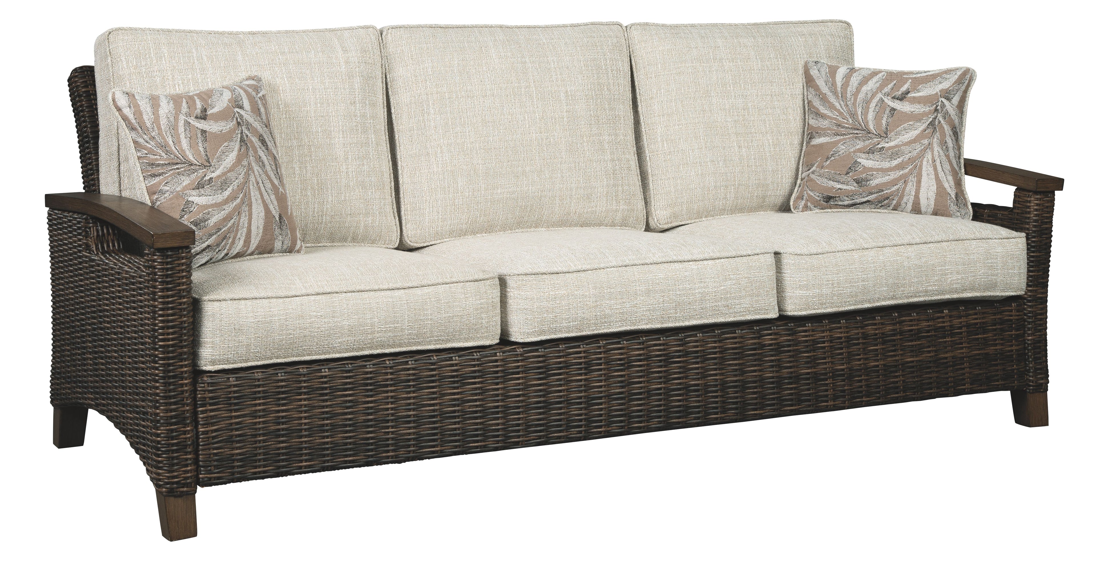 Medium brown wicker sofa with beige seat and back cushions, decorative throw pillows