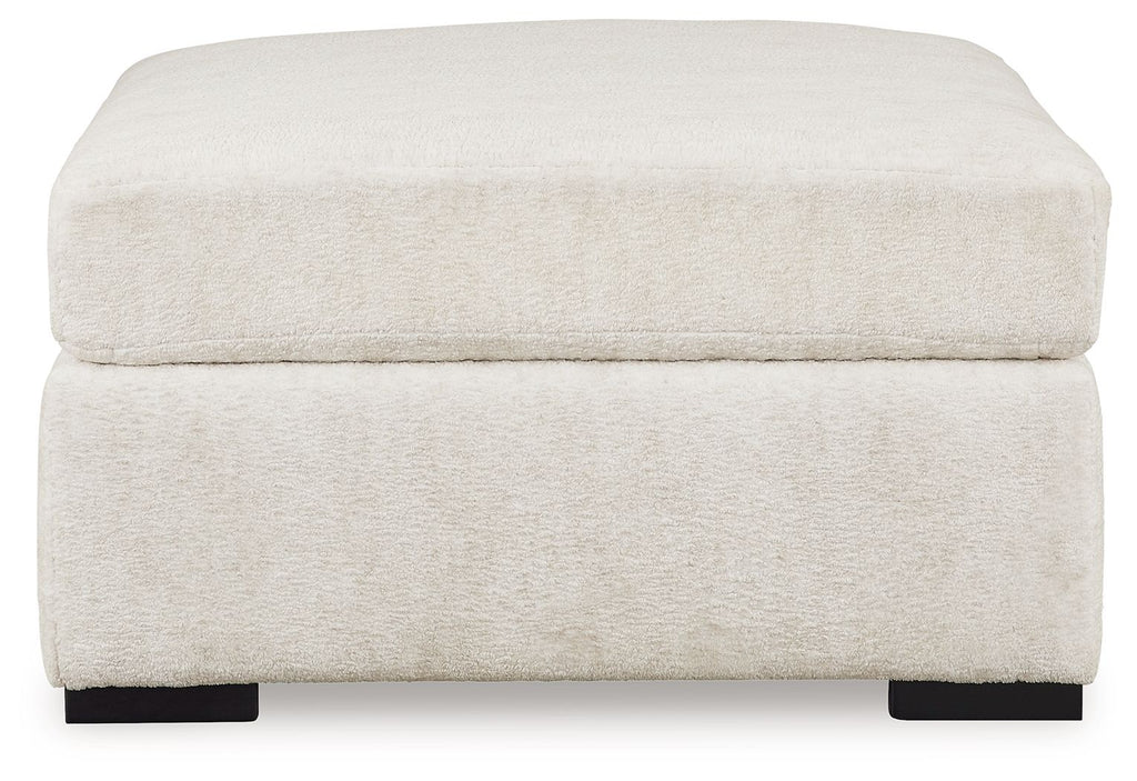 Ivory oversized accent ottoman with padded lid, straight sides, black feet