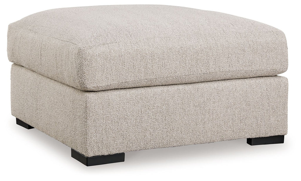 Sand-colored oversized accent ottoman with square top and dark block feet